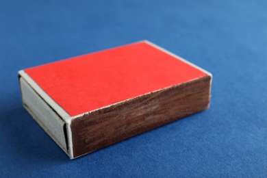 Red box of matches on color background, closeup