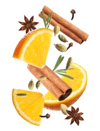 Image of Cut orange and different spices falling on white background. Mulled wine ingredients