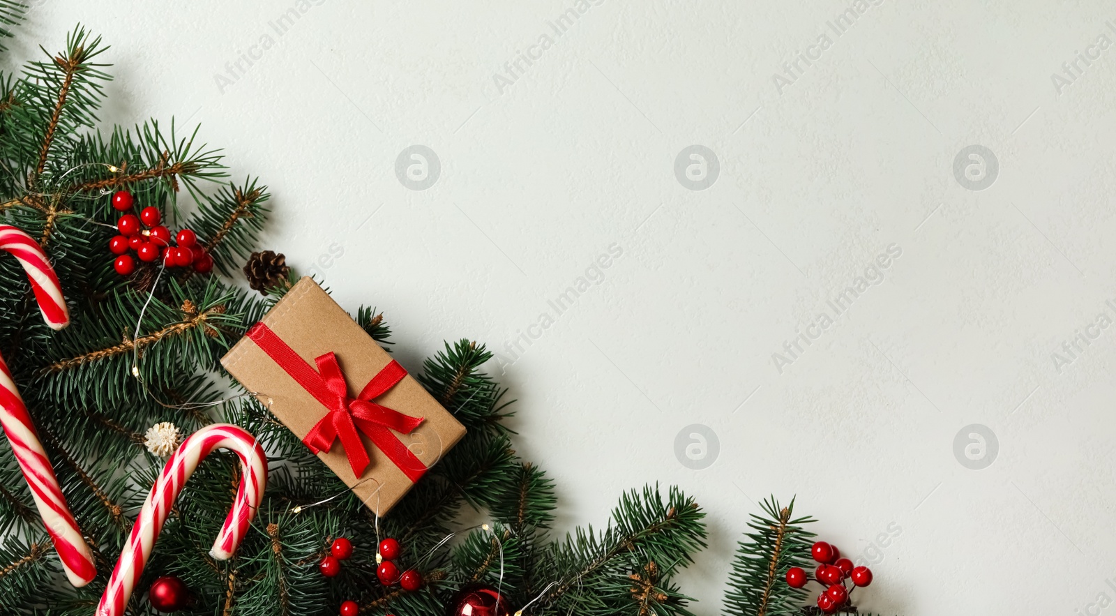 Photo of Christmas composition with gift box and festive decor on table, flat lay. Space for text