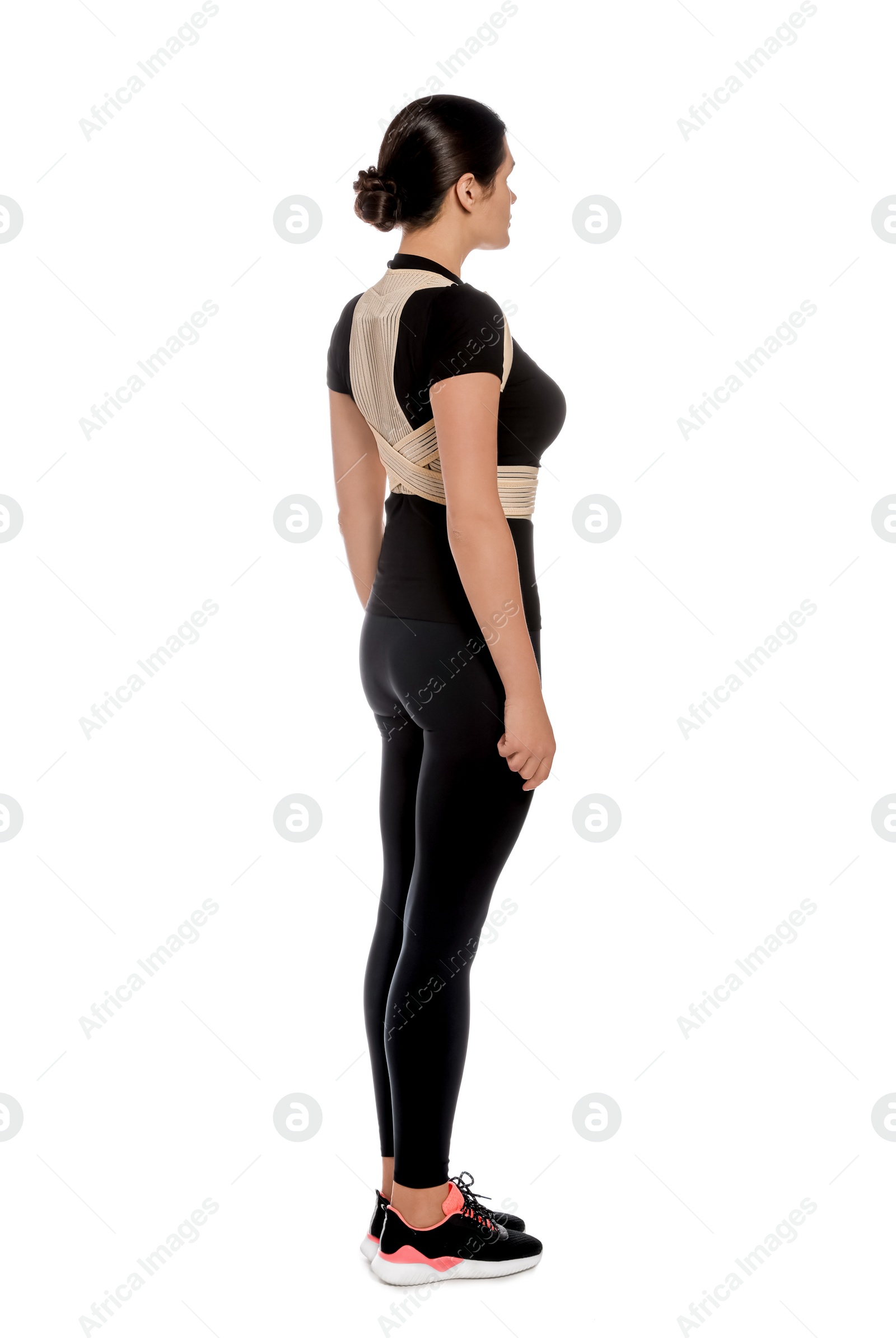 Photo of Beautiful woman with orthopedic corset on white background