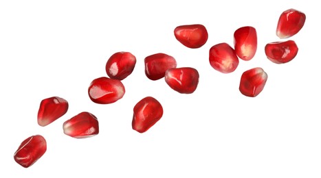 Image of Ripe juicy pomegranate seeds falling on white background. Banner design