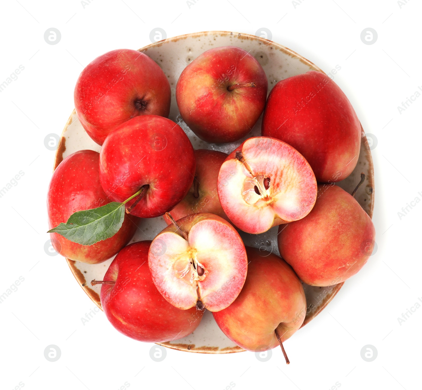 Photo of Plate of tasty apples with red pulp isolated on white, top view