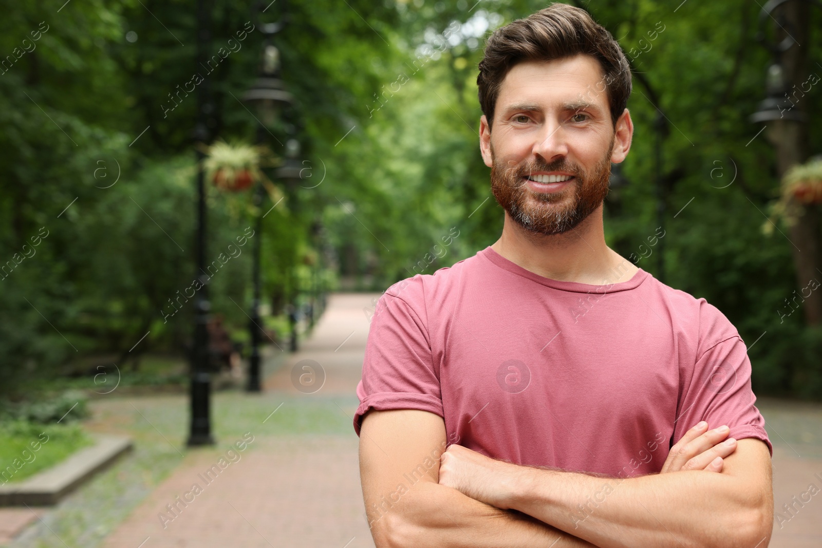 Photo of Portrait of handsome bearded man in park, space for text