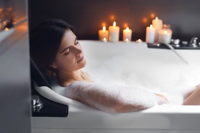 Beautiful woman taking bubble bath. Romantic atmosphere