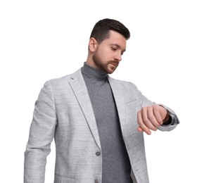 Handsome bearded businessman checking time on white background