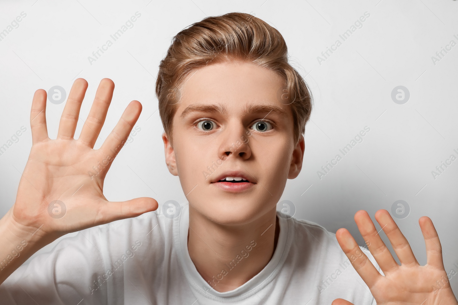 Photo of Excited teenage boy stuck to transparent screen