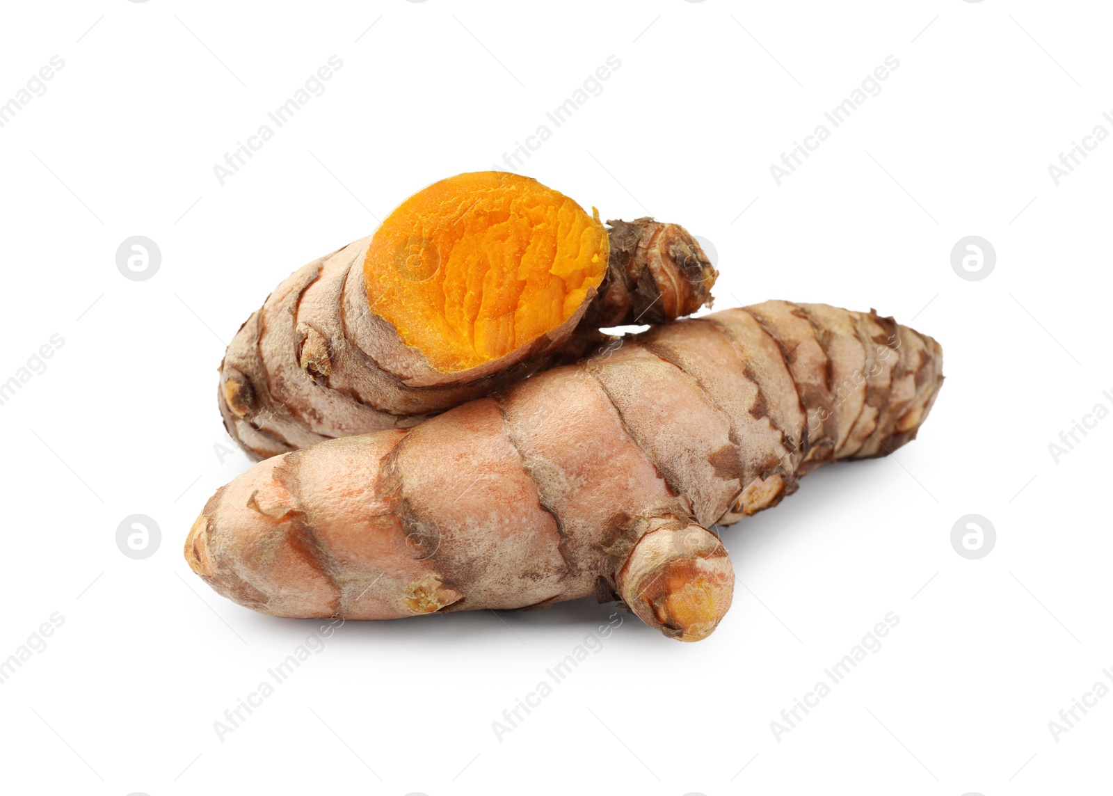 Photo of Whole and cut turmeric roots isolated on white