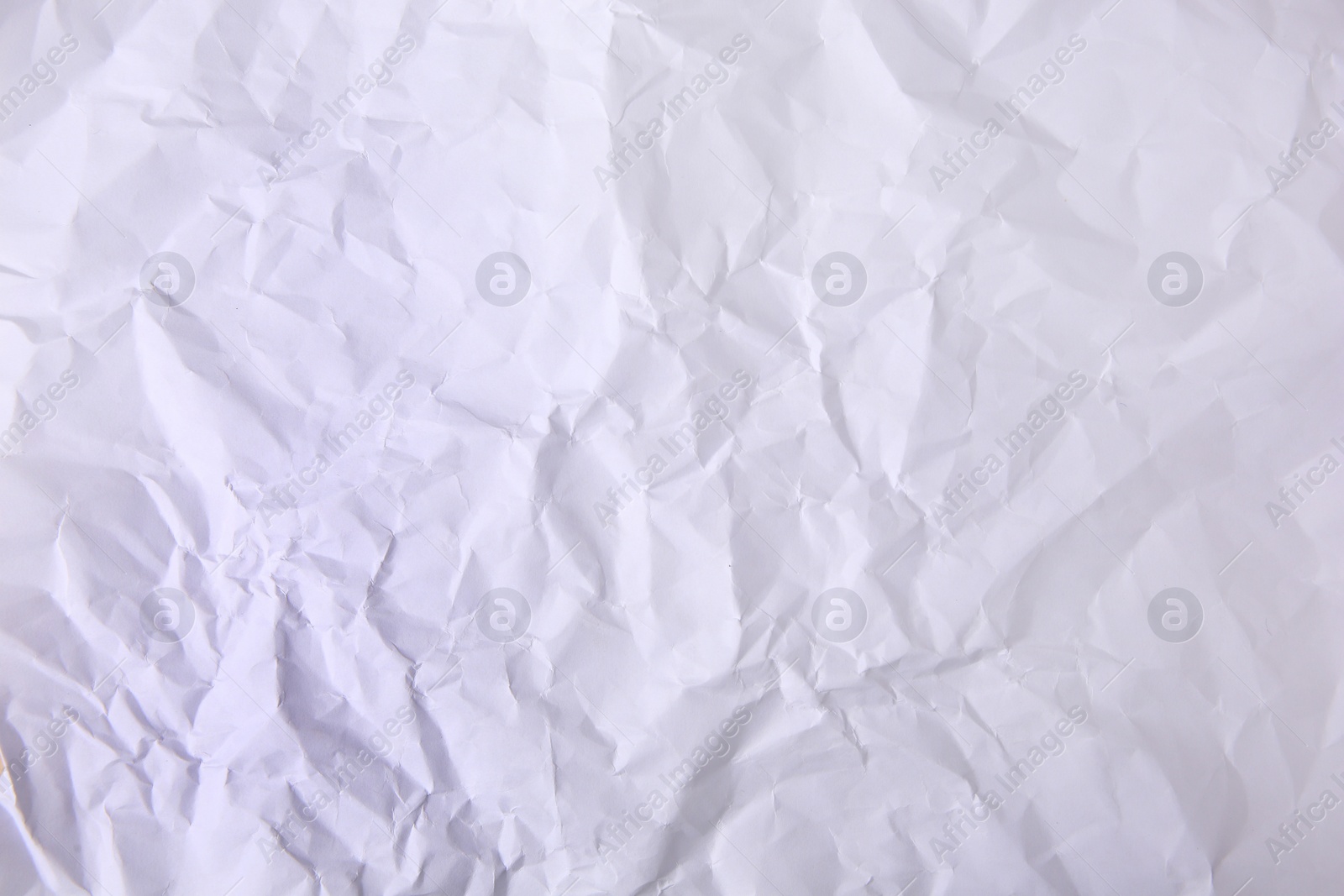 Photo of Sheet of crumpled paper white as background, top view