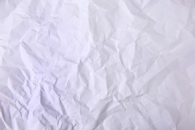 Sheet of crumpled paper white as background, top view