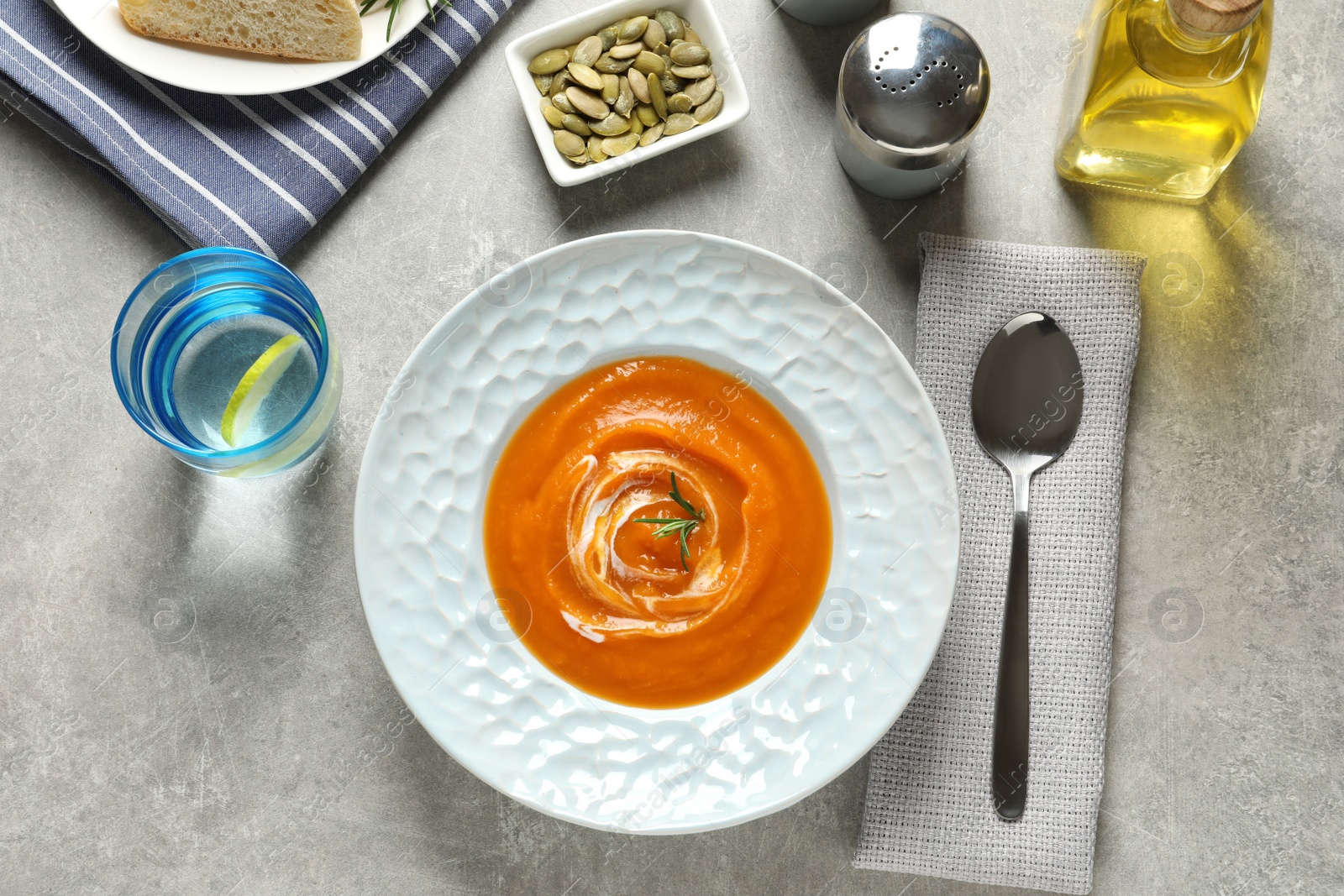 Photo of Plate of tasty sweet potato soup served on table, top view