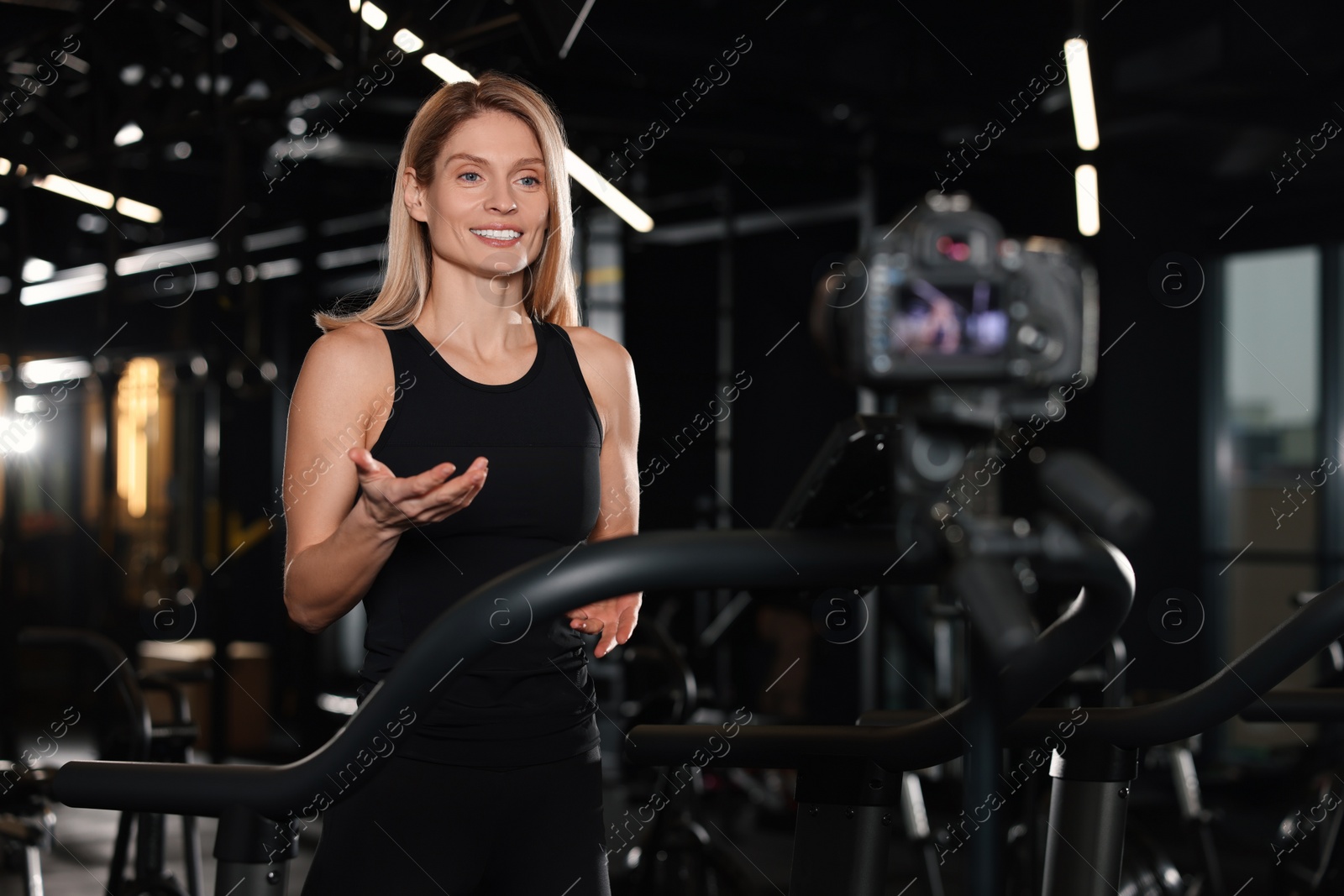 Photo of Fitness trainer recording online classes in gym