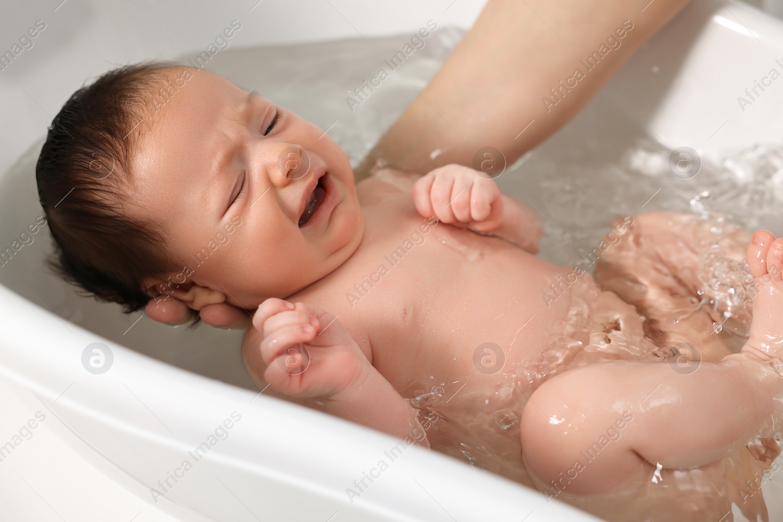 Photo of Mother bathing her cute little baby in bathtub