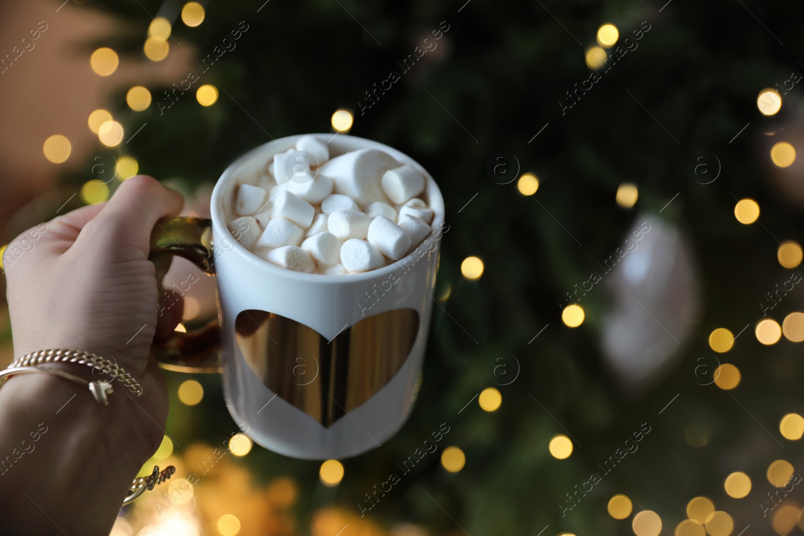 Photo of Woman with cup of cocoa indoors, closeup. Christmas mood