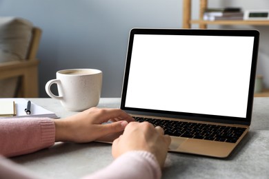 Photo of Woman working on laptop at white table, closeup. Mockup for design