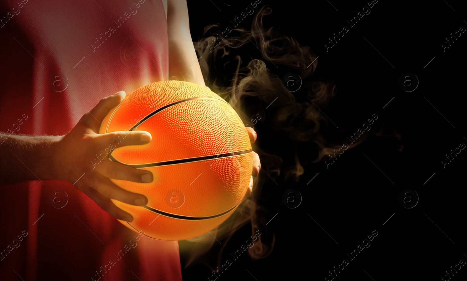 Image of Basketball player with hot ball on black background, closeup. Space for text