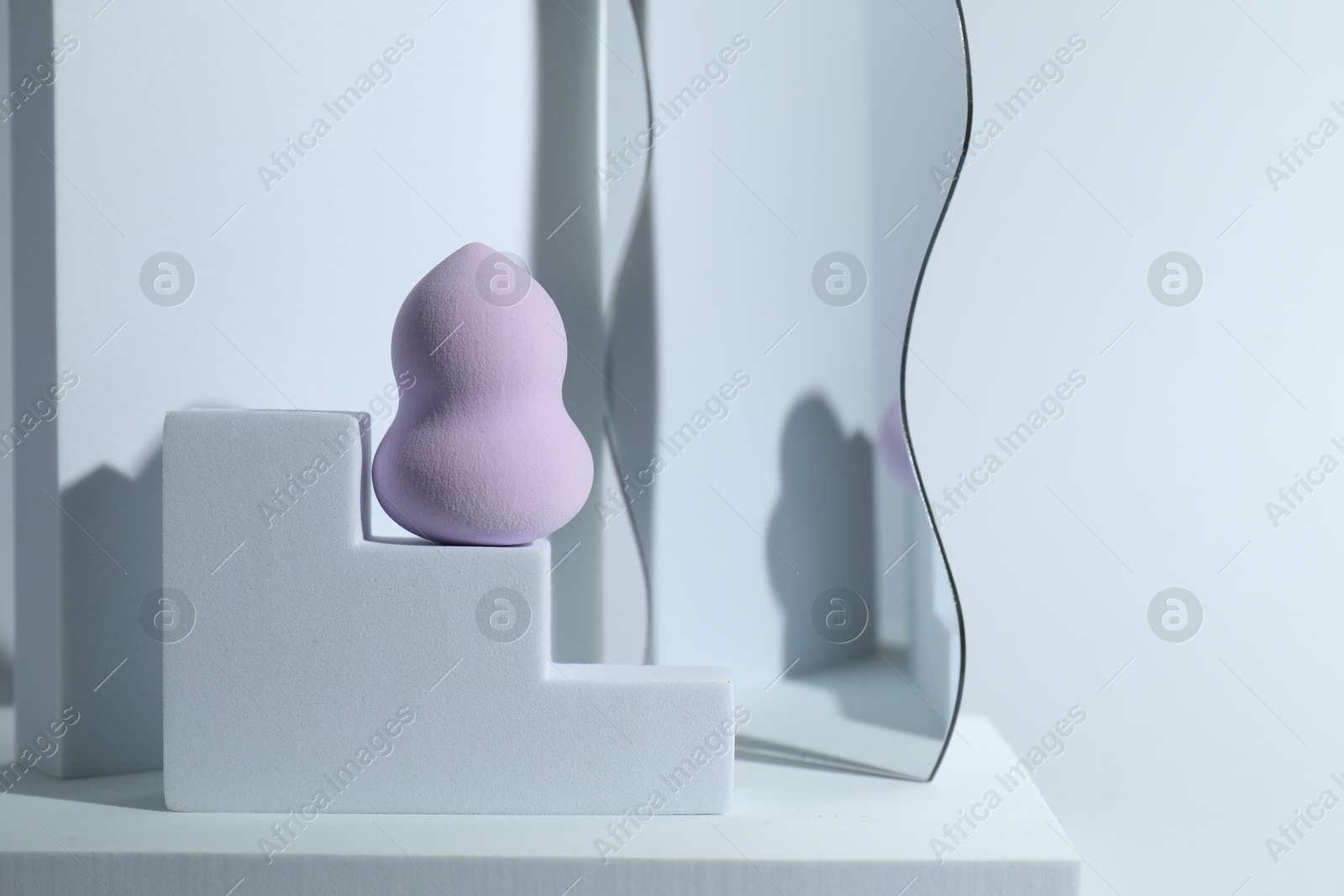 Photo of Stylish presentation of makeup sponge on light grey background