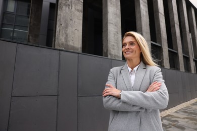 Portrait of smiling woman outdoors, space for text. Lawyer, businesswoman, accountant or manager