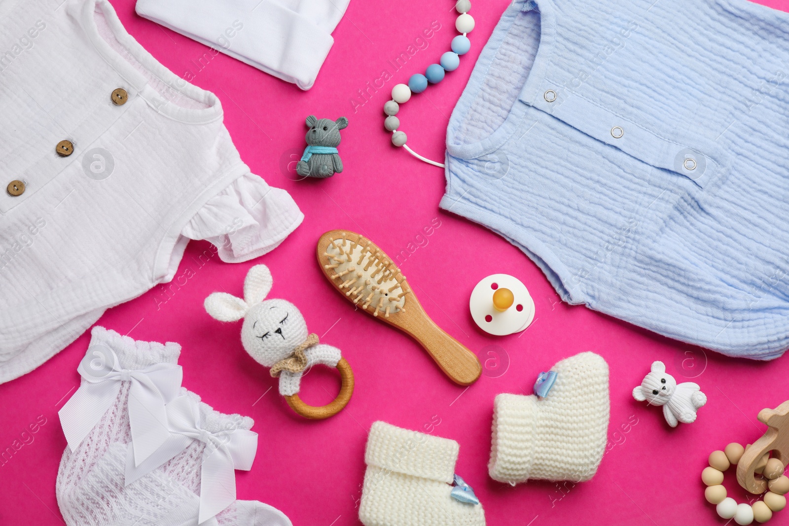 Photo of Flat lay composition with baby clothes and accessories on pink background