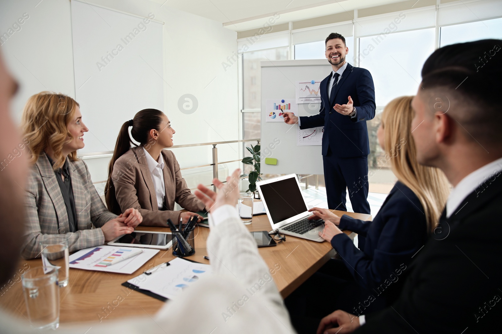 Photo of Businesspeople having meeting in office. Management consulting