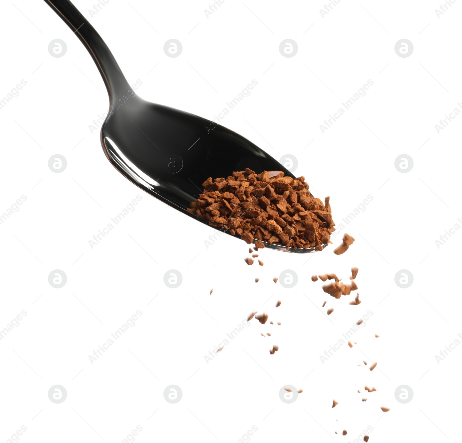 Photo of Pouring aromatic instant coffee from spoon on white background