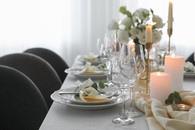 Photo of Festive table setting with beautiful floral decor in restaurant, space for text