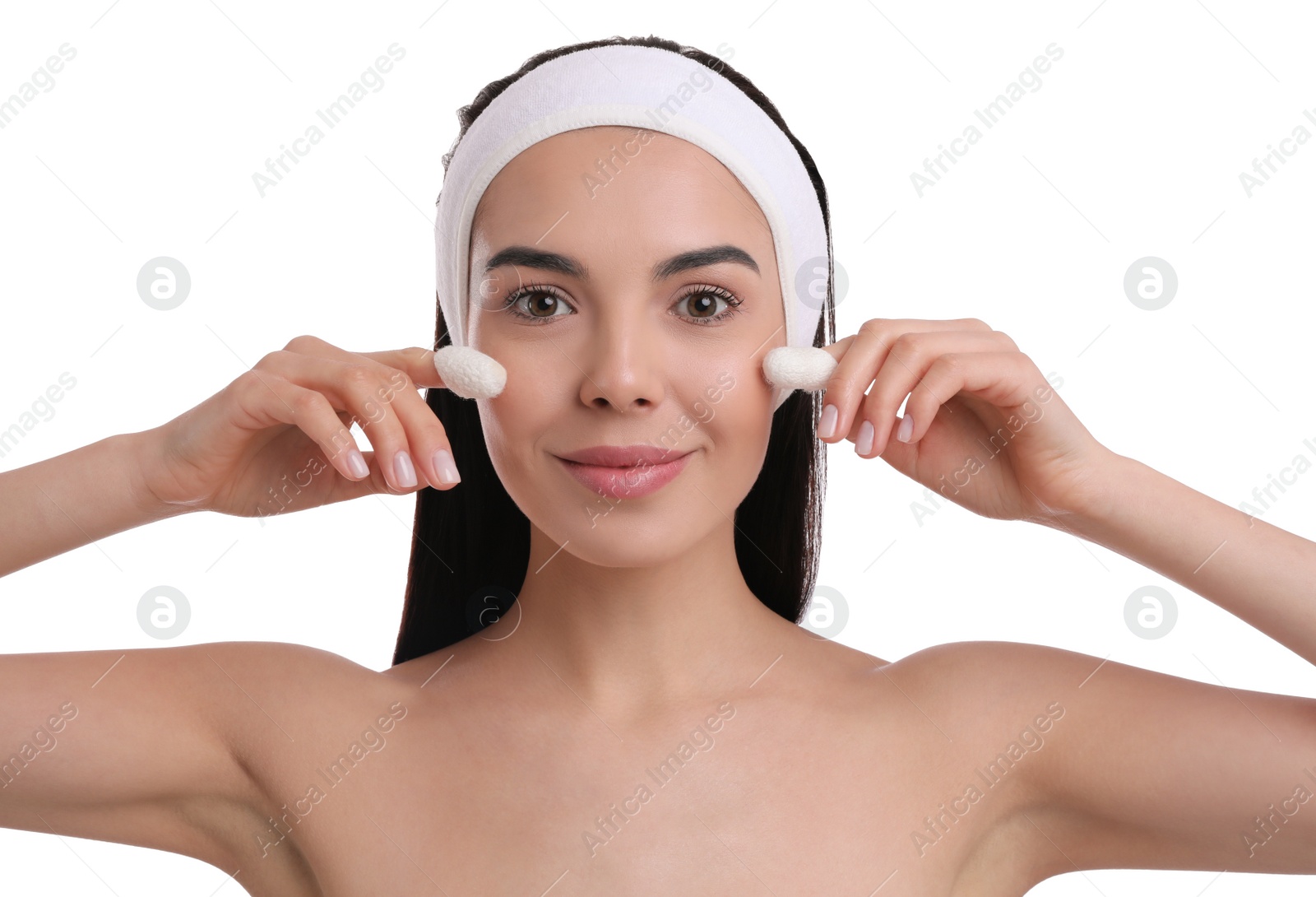 Photo of Woman using silkworm cocoons in skin care routine on white background