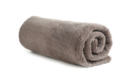 Photo of Rolled soft terry towel on white background