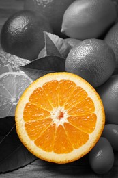 Fresh juicy citrus fruits with on table, closeup. Black and white tone with selective color effect