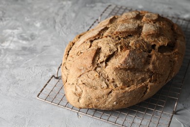 Freshly baked sourdough bread on grey table, closeup. Space for text