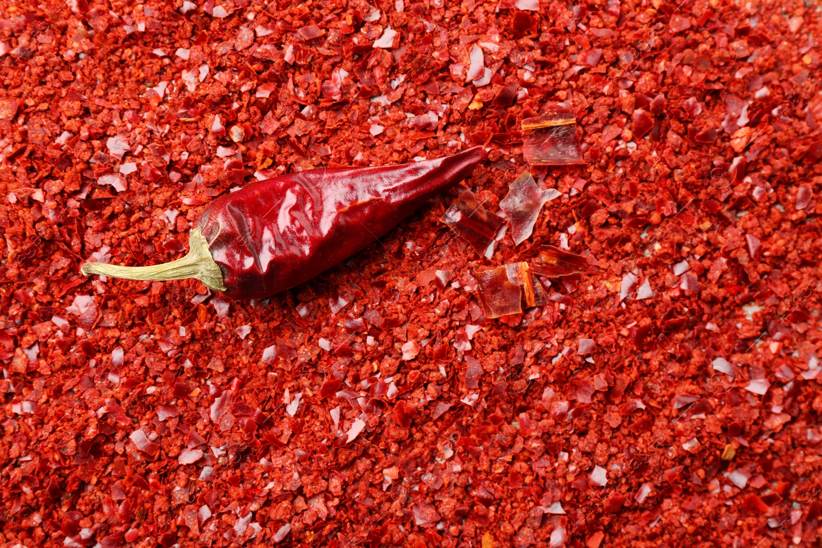 Photo of Chili pepper flakes as background, closeup