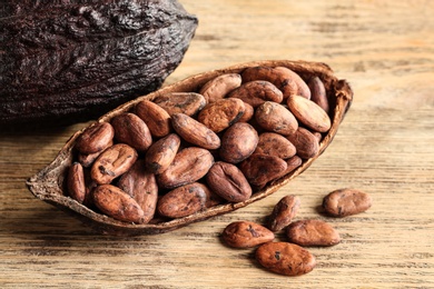 Photo of Cocoa pod of beans on wooden table