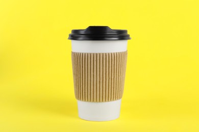 Photo of Paper cup with plastic lid on yellow background. Coffee to go