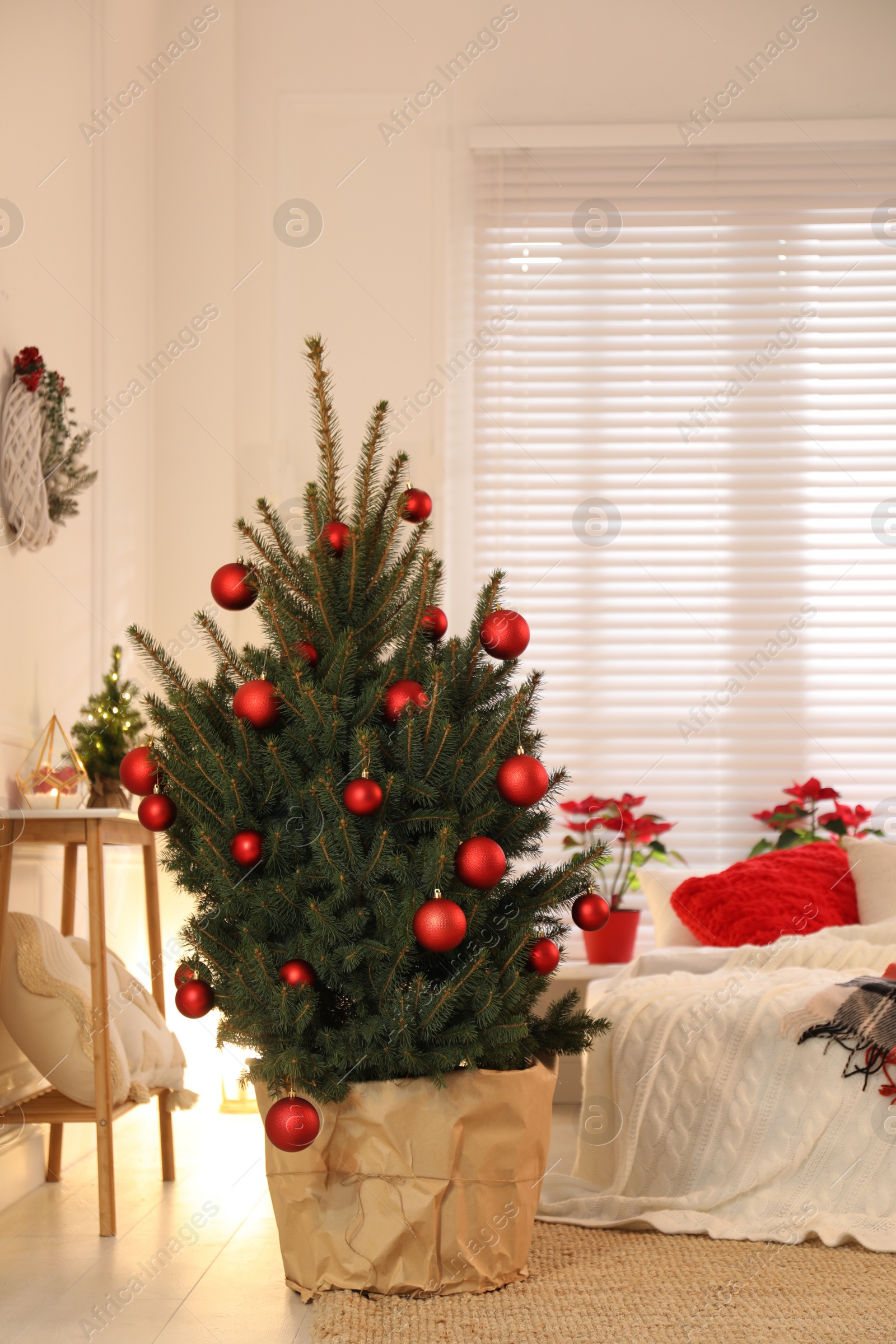 Photo of Beautiful decorated Christmas tree in bedroom. Interior design