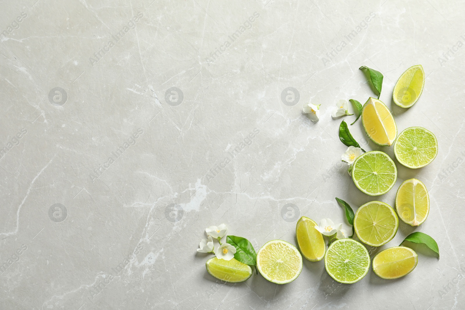 Photo of Composition with fresh ripe limes on light background, top view