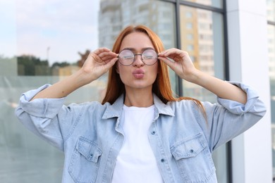 Portrait of beautiful woman in glasses outdoors