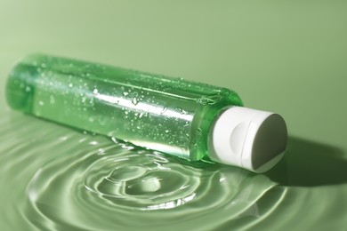 Photo of Bottlemicellar water in liquid on green background
