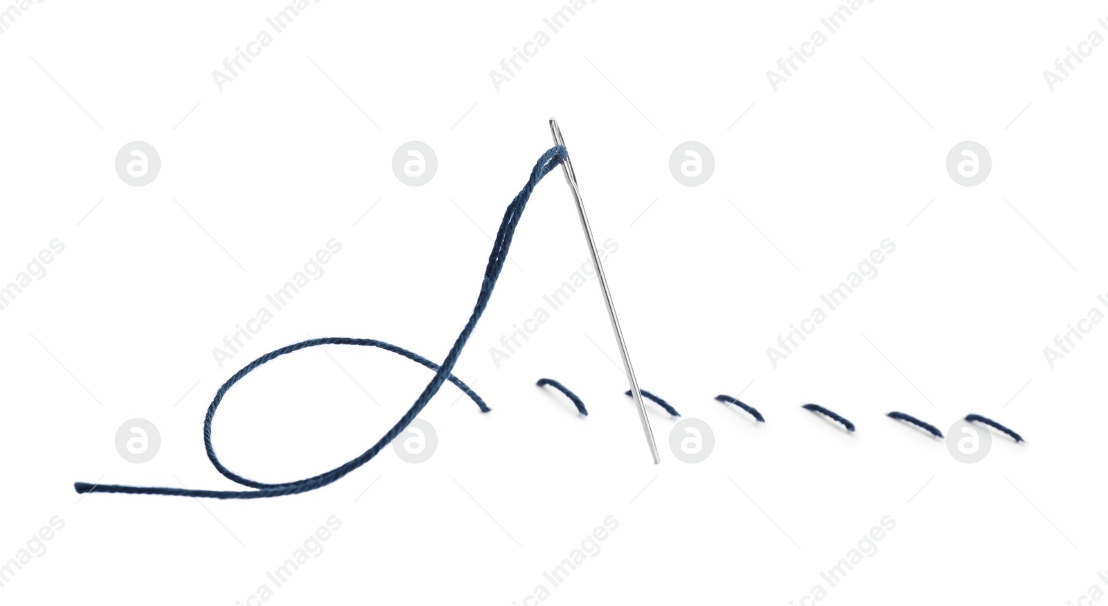 Photo of Needle with blue sewing thread on white background