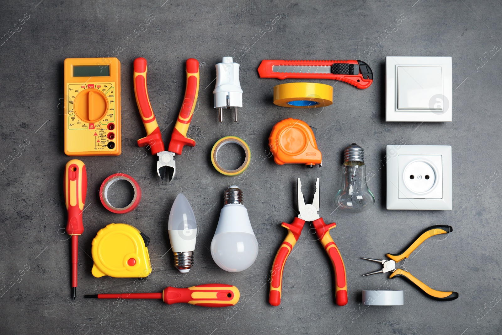 Photo of Flat lay composition with electrician's tools on gray background