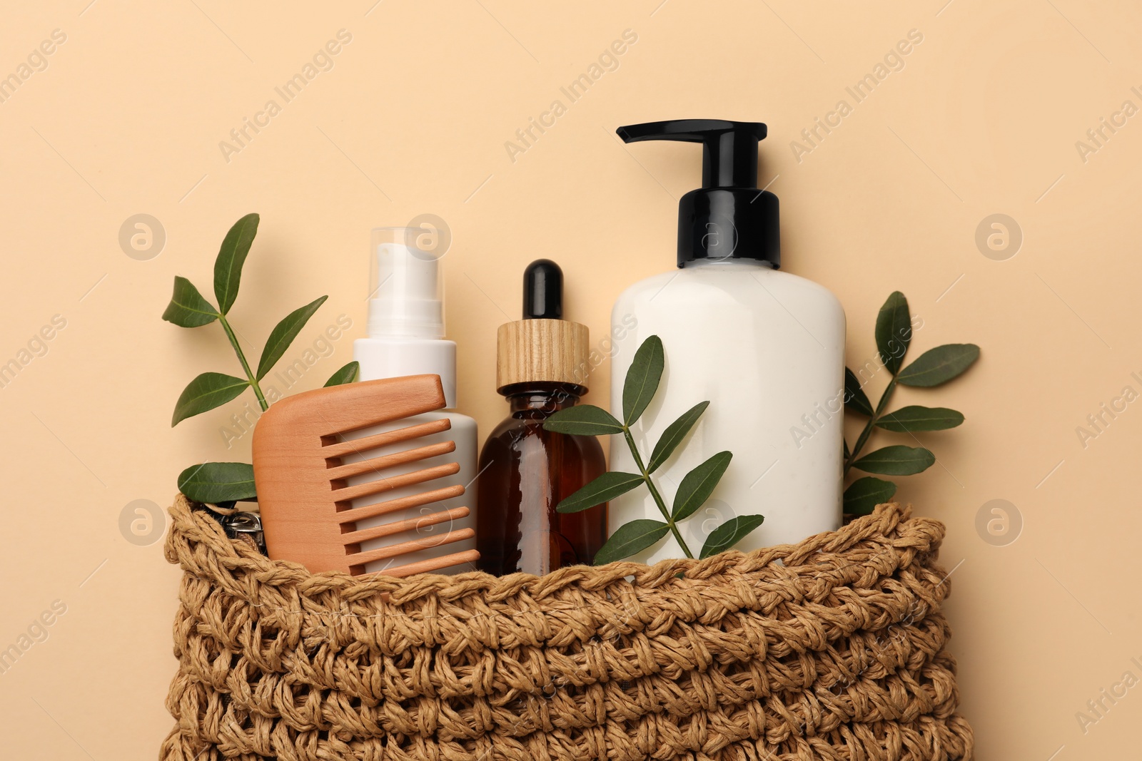 Photo of Preparation for spa. Compact toiletry bag with different cosmetic products on beige background, flat lay