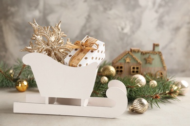 Beautiful Christmas composition with miniature sleigh on light table