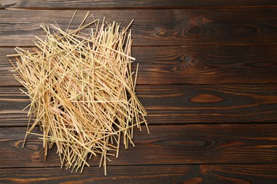 Dried hay on wooden background, top view. Space for text