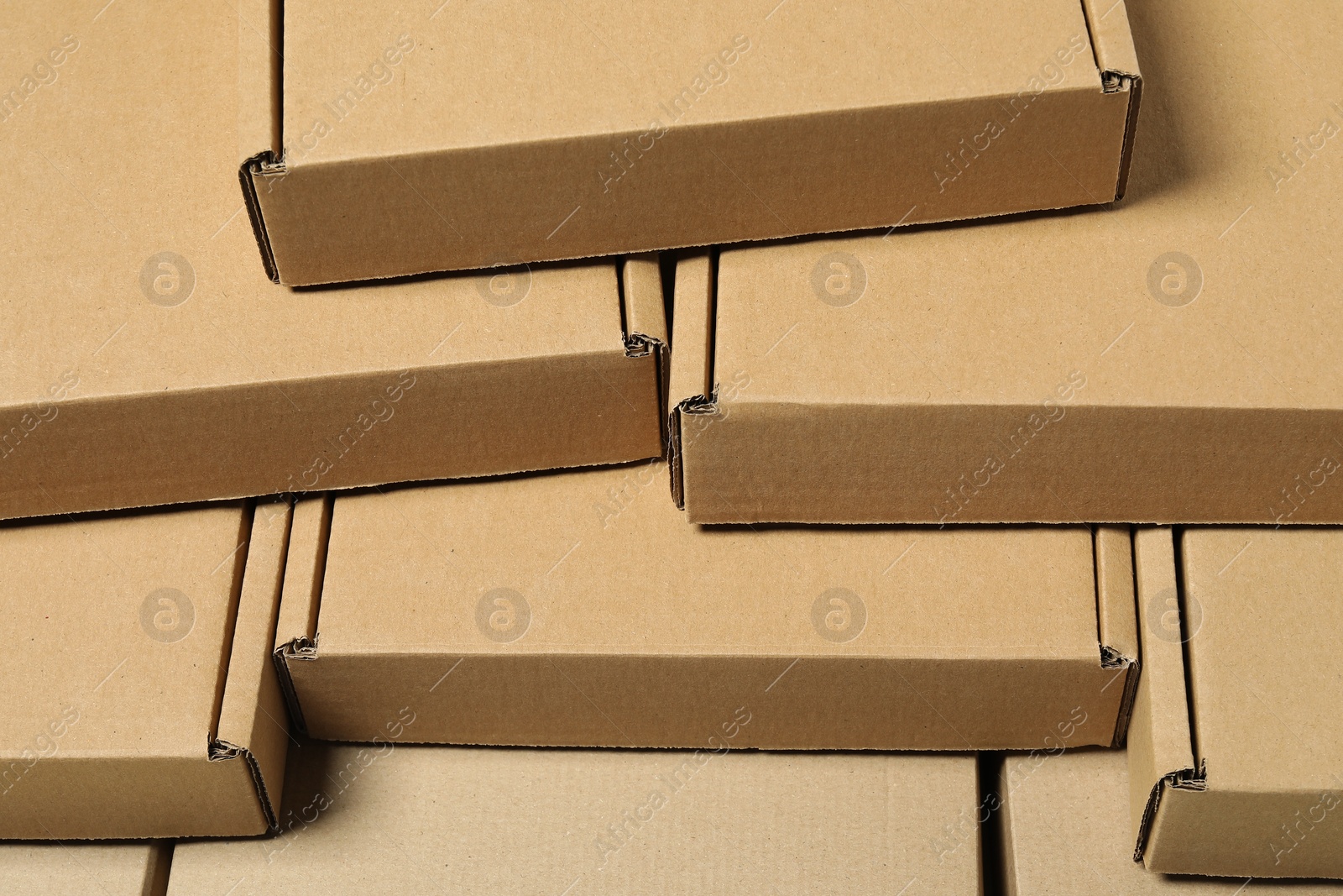 Photo of Many closed cardboard boxes as background, closeup