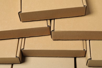 Many closed cardboard boxes as background, closeup