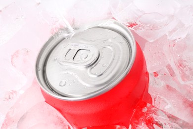 Photo of Energy drink in wet can and ice cubes, closeup