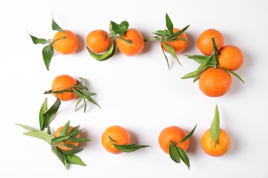 Frame made of ripe tangerines on white background, top view. Space for text