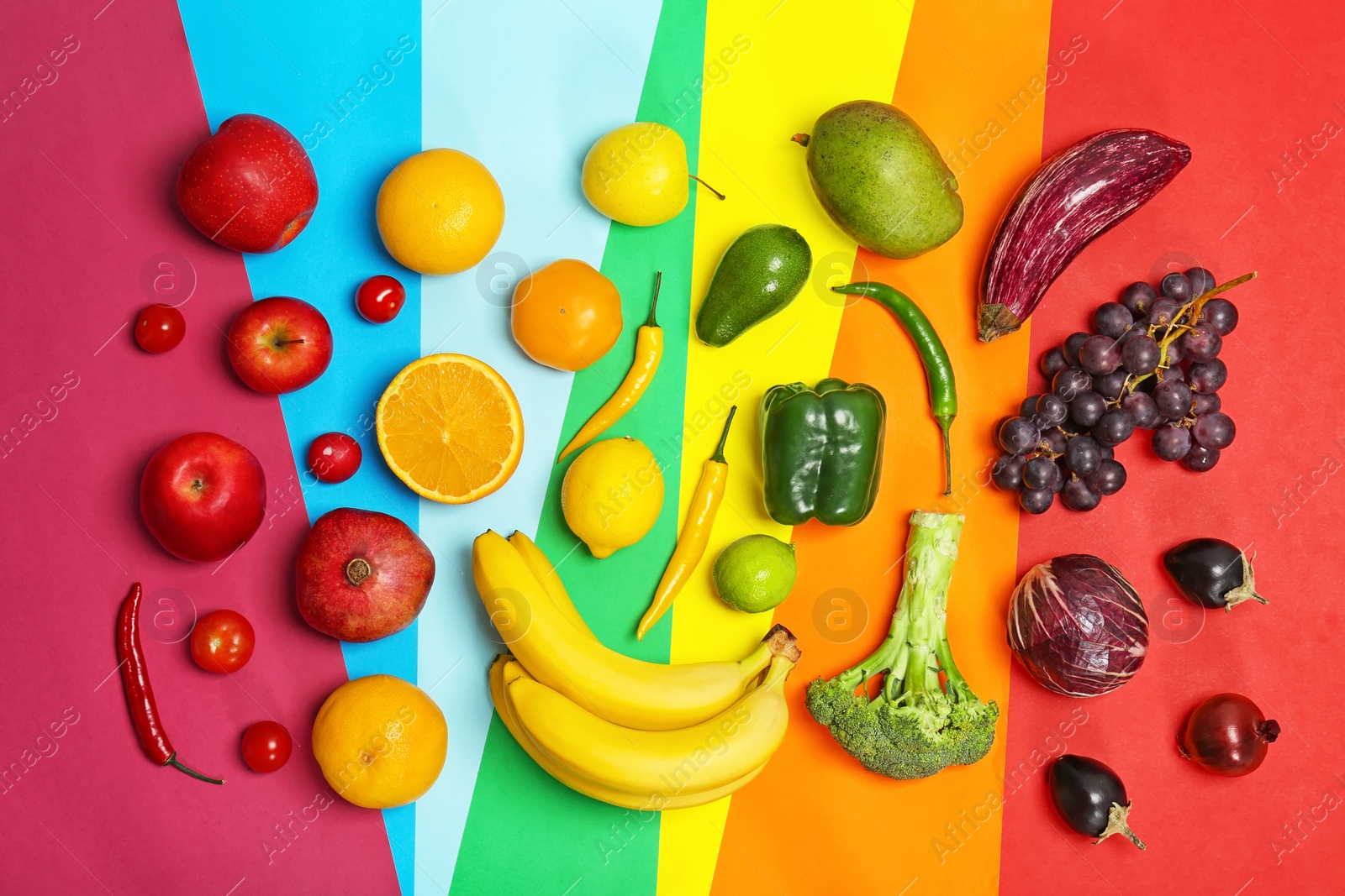 Photo of Rainbow composition with fresh vegetables and fruits on color background, flat lay