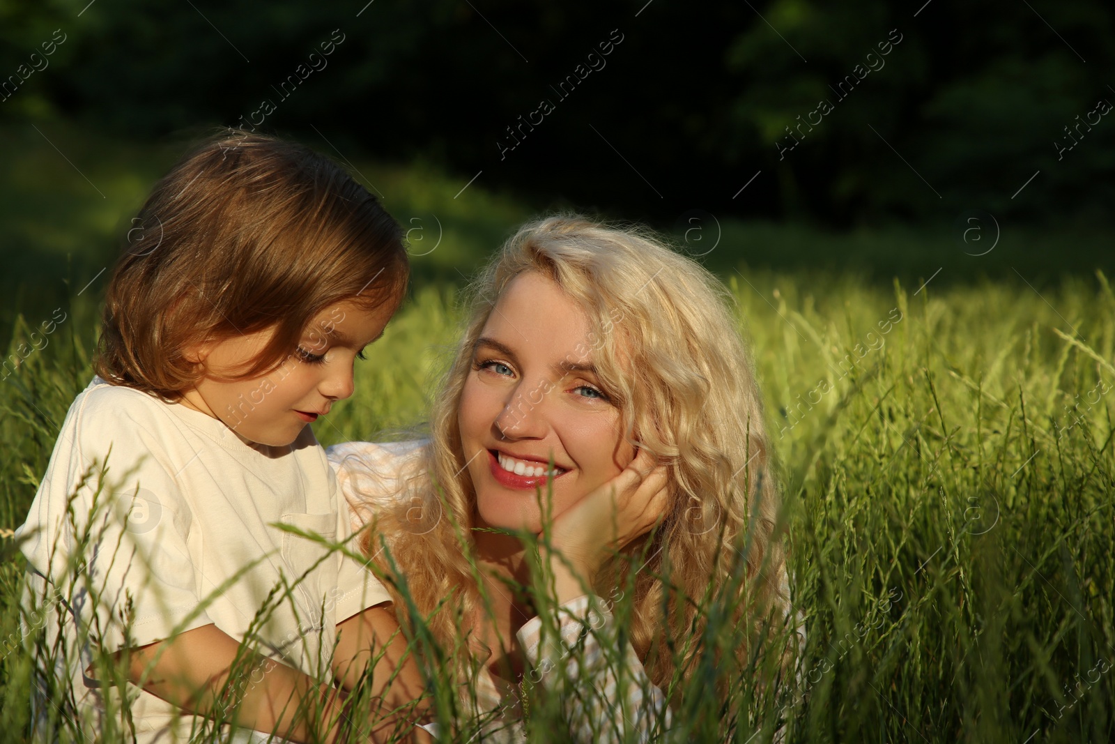 Photo of Happy mother with her cute daughter spending time together outdoors