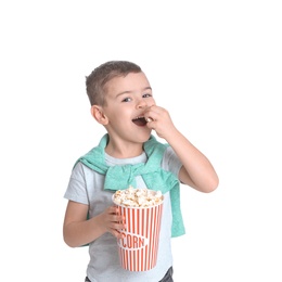 Photo of Cute little boy with popcorn on white background