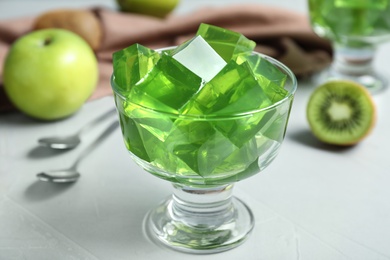 Photo of Bowl with green fruit jelly on light table