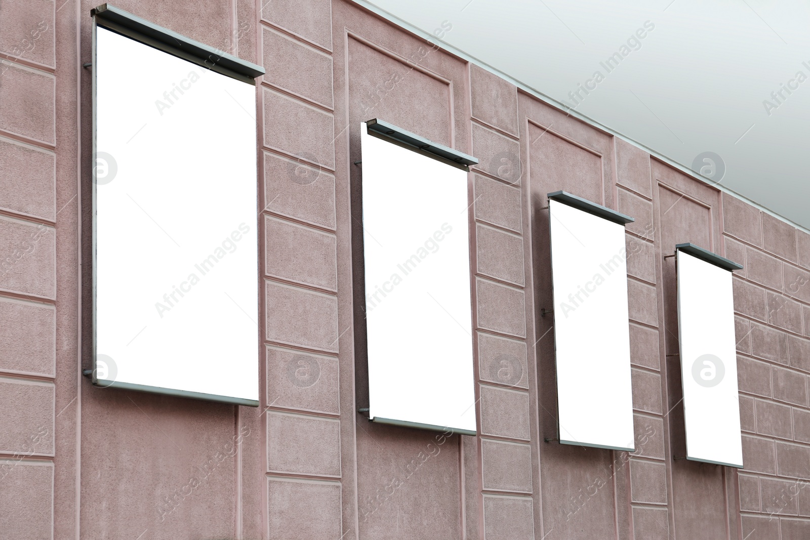 Photo of Blank banners on building facade outdoors. Advertising board design